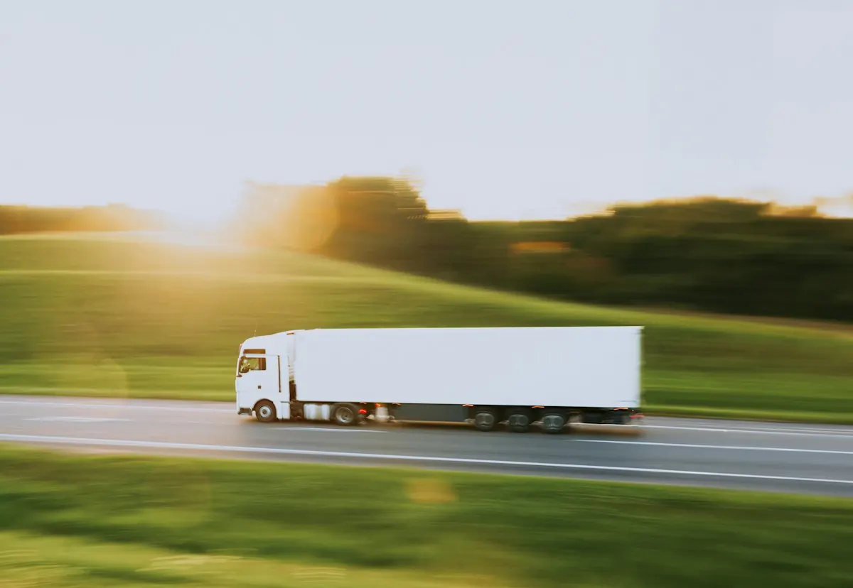 White truck driving on a highway